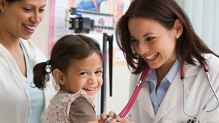 Gynecologist examining girl child at clinic