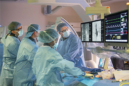 Team of doctors performing open vascular surgery