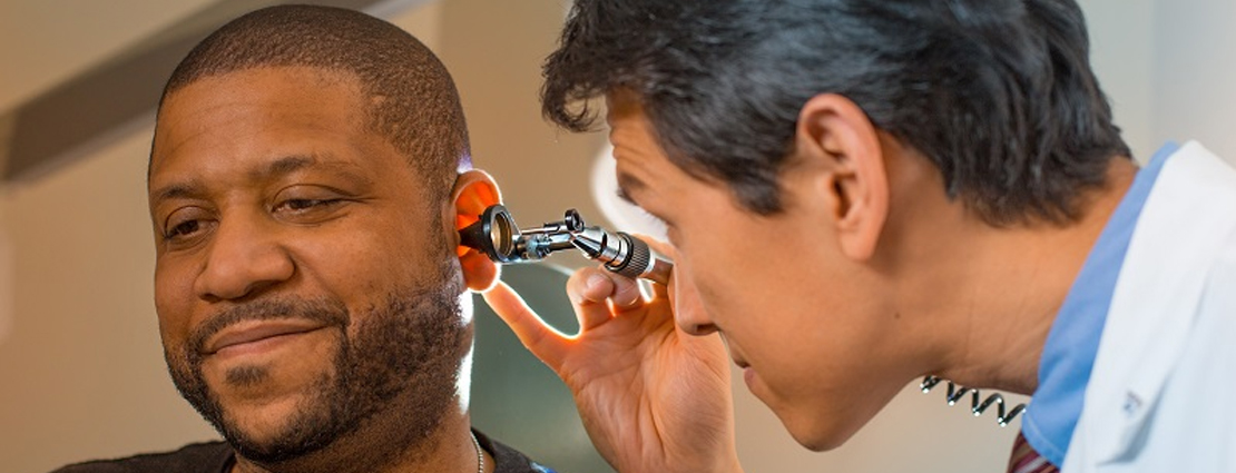Doctor examining patient’s ear