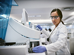Lab Specialist using a machine to conduct a medical test in a laboratory