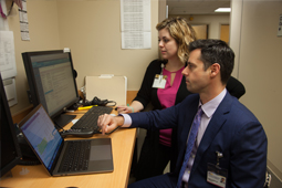 Nerve damage specialist examining reports on laptop