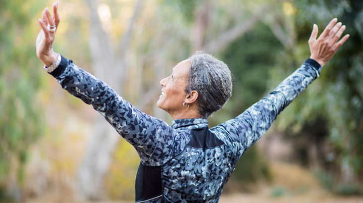 Pain free woman stretches her back