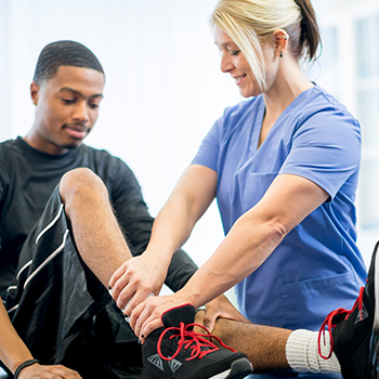 Health professional examining Patient’s leg